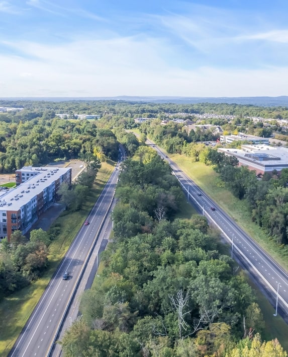 Aerial view of Garden State Parkway with highway and trees in the distance.